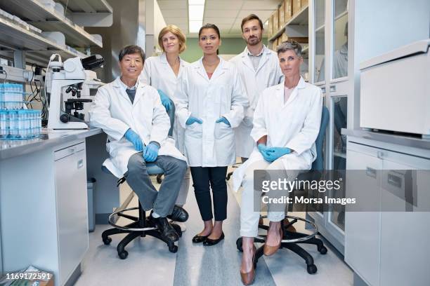 portrait of confident scientists in laboratory - medical research group stock pictures, royalty-free photos & images
