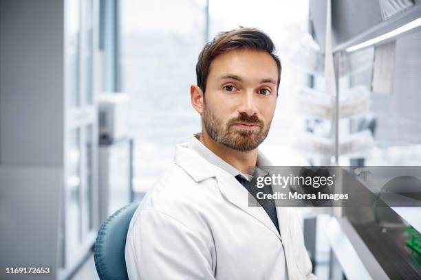 confident male doctor at research center - scientist clean suit stock pictures, royalty-free photos & images