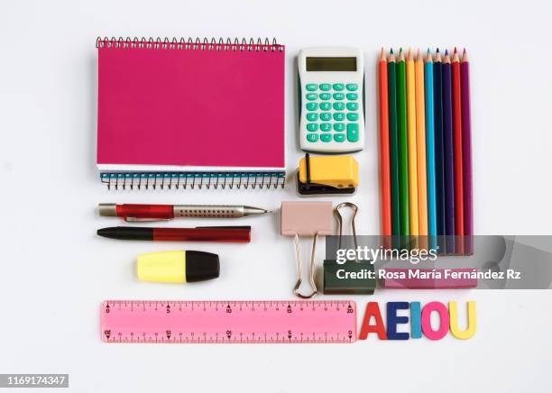 directly above shot of school supplies on white background. - schulbedarf stock-fotos und bilder
