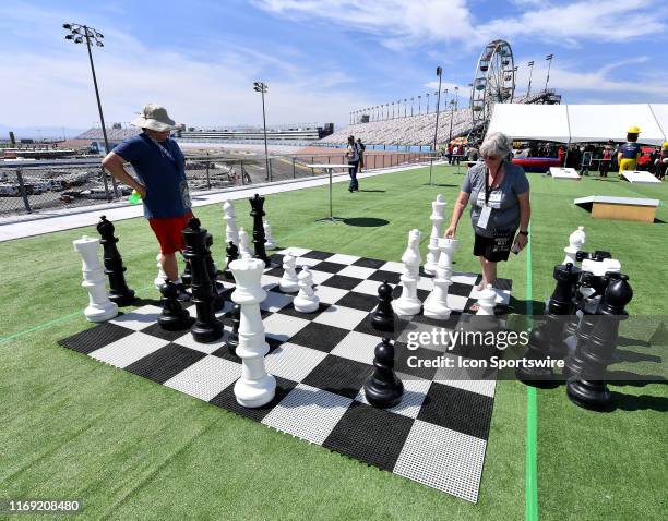 Race fans play a game of chess in the Turn 4 Turn Up area prior to the Monster Energy NASCAR Cup Series South Point 400 playoff race Sunday Sept. 15,...
