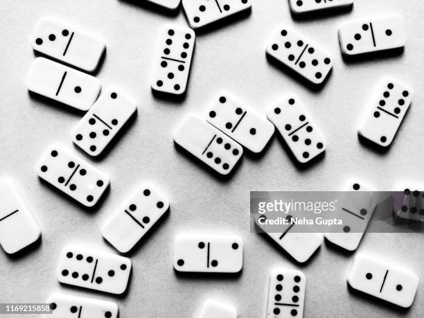 domino pieces isolated on a textured background - monochrome - gambling table stock pictures, royalty-free photos & images