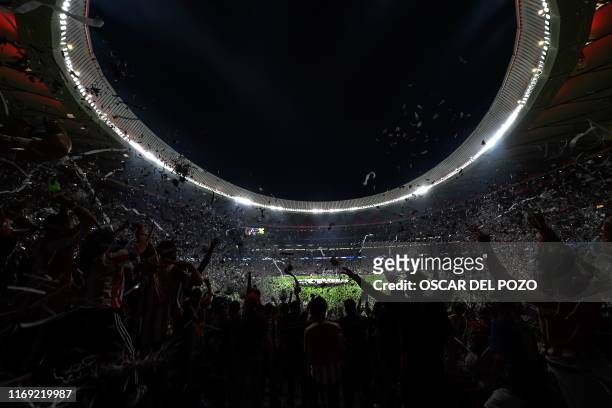 Supporters cheer from the stands prior to the UEFA Champions League Group D football match between Atletico Madrid and Juventus, at The Wanda...