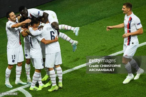 Paris Saint-Germain's Argentine midfielder Angel Di Maria celebrates with teammates after scoring a goal during the UEFA Champions league Group A...