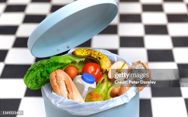 kitchen bin with out of date food - leftover stockfoto's en -beelden