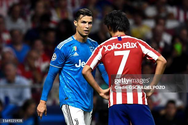 Atletico Madrid's Portuguese forward Joao Felix speaks with Juventus' Portuguese forward Cristiano Ronaldo during the UEFA Champions League Group D...