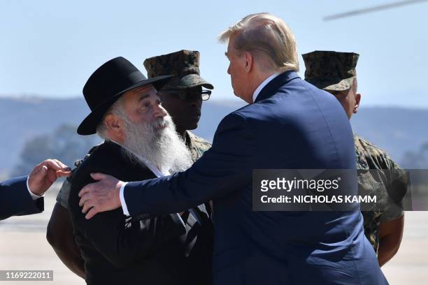 President Donald Trump is greeted by Chabad of Poway synagogue Rabbi Yisroel Goldstein upon arrival at Miramar Marine Corps Air Station in San Diego,...