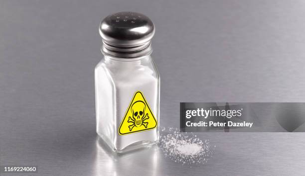 salt cellar using too much salt, warning sign showing the health risk - hypertensive stock pictures, royalty-free photos & images