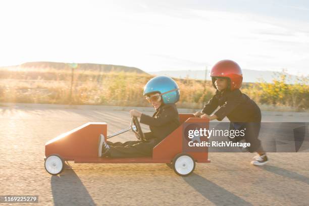 young business boys rasen ein spielzeugauto - car photos stock-fotos und bilder