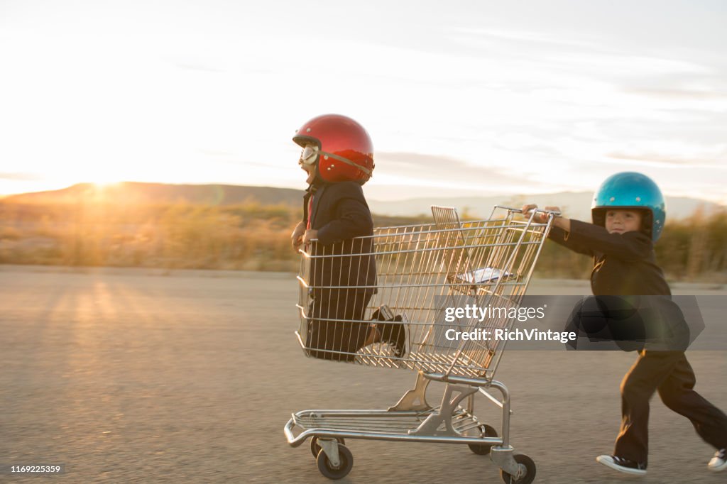 Young Business Boys Racing a Shopping Cart