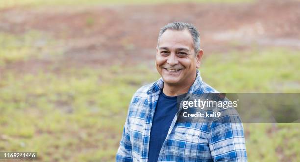mature hispanic man wearing plaid shirt - man wearing plaid shirt stock pictures, royalty-free photos & images