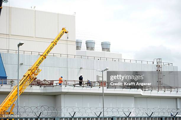 Workers are seen at the nuclear power plant during activists attempt to block access to the Brokdorf nuclear power plant on June 18, 2011 in Brokdorf...