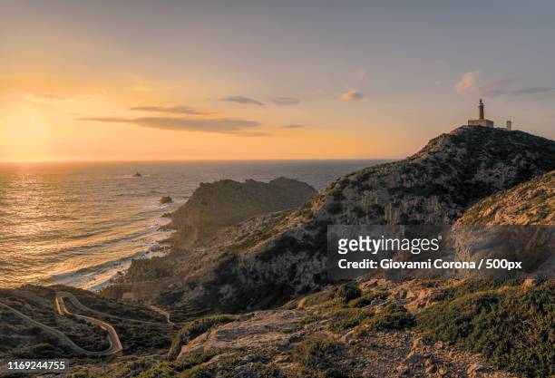sunset in carloforte lighthouse - sardinien stock-fotos und bilder