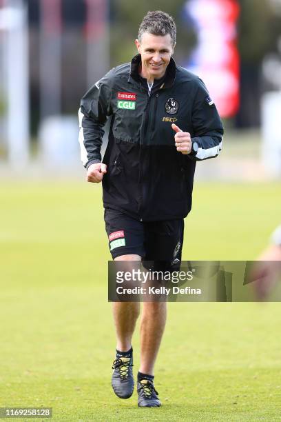 Justin Longmuir Assistant Coach of the Magpies runs during a Collingwood Magpies AFL training session at The Holden Centre on August 21, 2019 in...