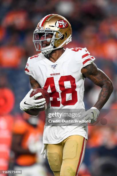 Defensive back Dontae Johnson of the San Francisco 49ers carries the ball off the field after a fourth quarter interception against the Denver...