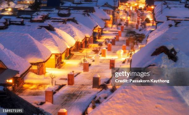 japan winter train - snow covered road stockfoto's en -beelden