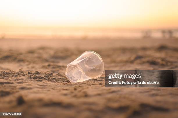 disposable cup abandonned on the beach - disposable cup stock pictures, royalty-free photos & images
