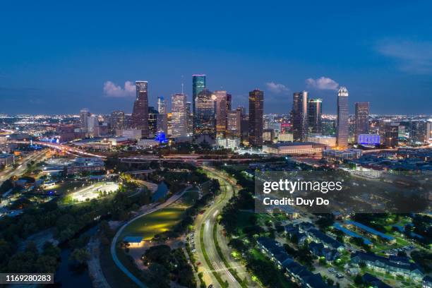 night aerial view taking by drone of skyline downtown houston , texas in the evening - downtown houston stock pictures, royalty-free photos & images