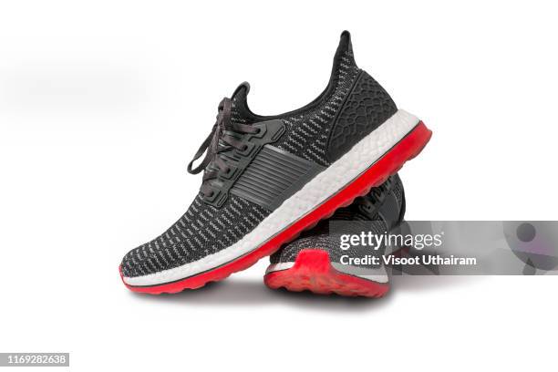 running shoe isolated on white background. - running shoe fotografías e imágenes de stock