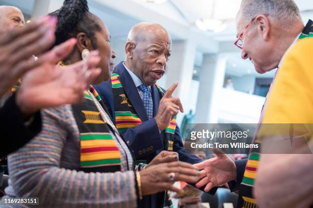 Rep. John Lewis, D-Ga., left, and Senate Minority Leader Chuck Schumer, D-N.Y., attend a ceremony in the Capitols Emancipation Hall to mark the the...