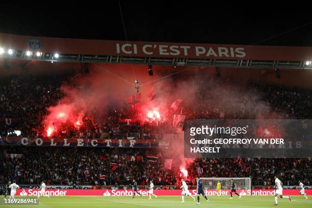 Paris Saint-Germain's supporters cheer during the UEFA Champions league Group A football match between Paris Saint-Germain and Real Madrid, at the...