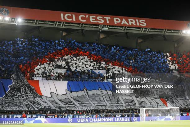 Paris Saint-Germain's supporters cheer at the start of the UEFA Champions league Group A football match between Paris Saint-Germain and Real Madrid,...