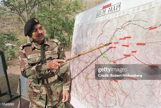 Pakistani Army Brigadier Muhammad Yaqub points to the Indian Army bunker on a map October 20, 2001 in Chakoti along the Line of Control on the...