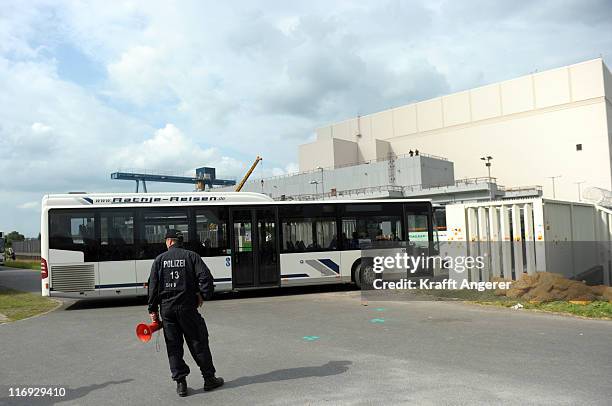 Workers of the nuclear plant arrive after the police raised the blackade of anti nuclear activists at the Brokdorf nuclear power plant on June 18,...