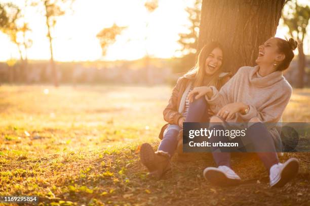 sitting under a tree - under value stock pictures, royalty-free photos & images