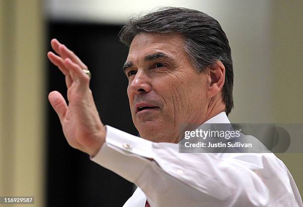 Texas governor Rick Perry waves as he signs copies of his book "Fed Up" during the 2011 Republican Leadership Conference on June 18, 2011 in New...