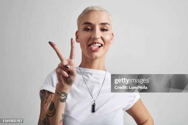 peace out world - tattoo woman stock pictures, royalty-free photos & images