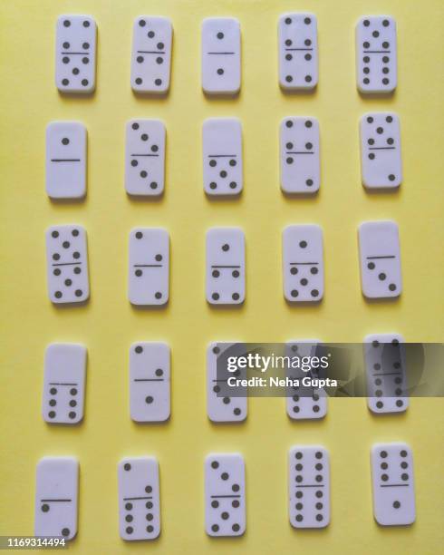 domino pieces isolated on yellow background - dominoes stock pictures, royalty-free photos & images