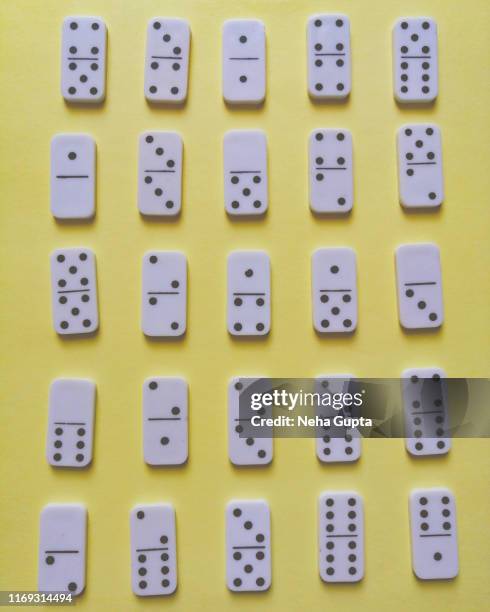 domino pieces isolated on yellow background - dominó imagens e fotografias de stock