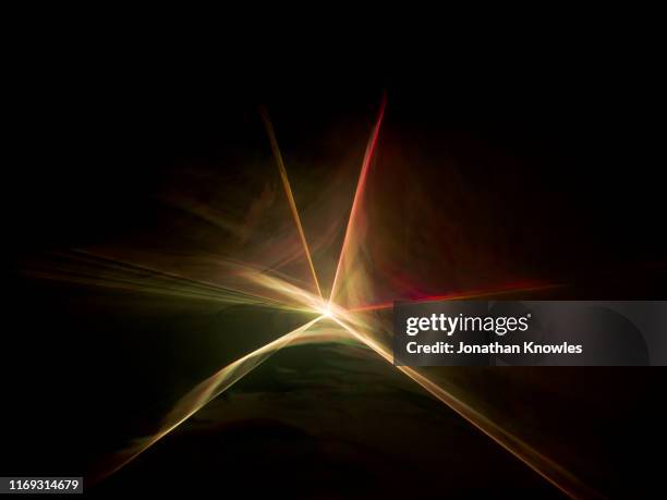 red and orange star laser beam - lense flare stock-fotos und bilder