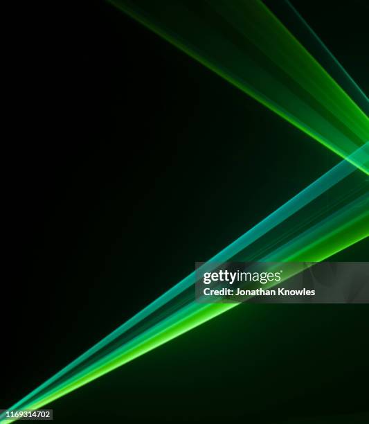 two green laser strips of light - sunbeam fotografías e imágenes de stock