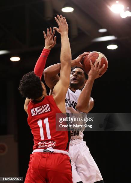 Corey Webster of New Zealand drives to the basket under pressure from Andrew Nembhard of Canada during the International Basketball Friendly match...