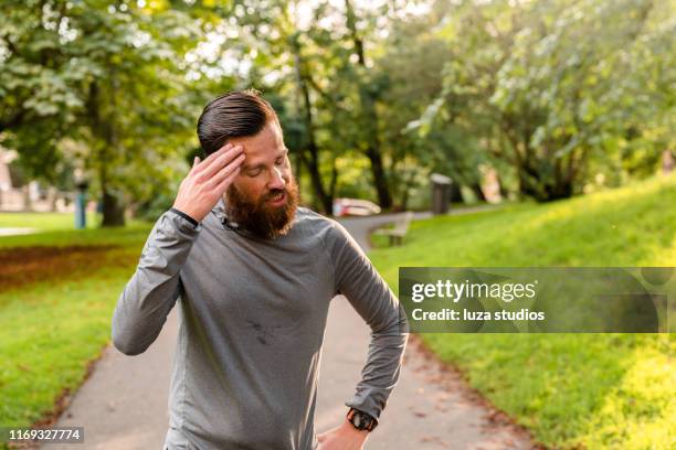 swedish man is exhausted after exercising in e public park - manga comprida imagens e fotografias de stock