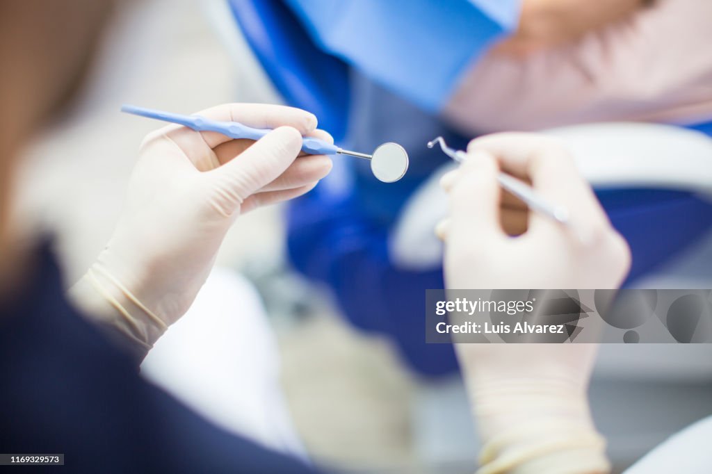 Dentist at work with tools
