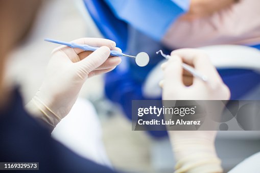 Dentist at work with tools Dentist at work with tools