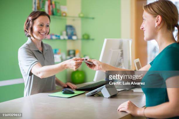 woman attending customer at dental pharmacy - dental office bildbanksfoton och bilder