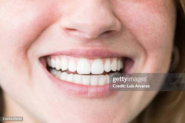 woman with beautiful toothy smile - zahn stock-fotos und bilder