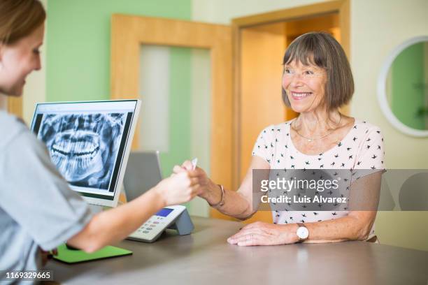 senior woman at dental clinic for treatment - dental office bildbanksfoton och bilder