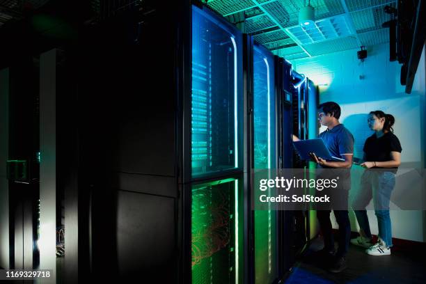 technicians working in server room - supercomputer data stock pictures, royalty-free photos & images