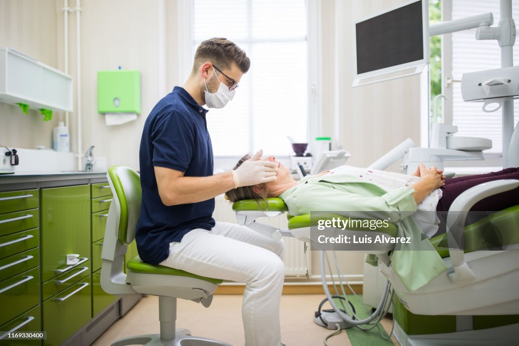 Dental doctor examining woman patient