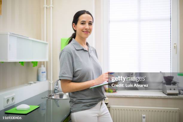 woman working in a clinic - infermiera foto e immagini stock