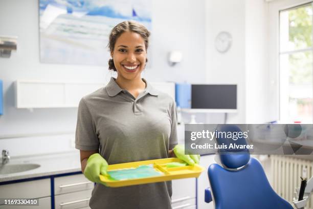 portrait of confident female dentist's assistant - sprechstundenhilfe stock-fotos und bilder