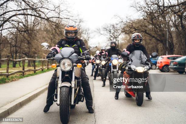 female bikers on road - riding motorcycle stock pictures, royalty-free photos & images