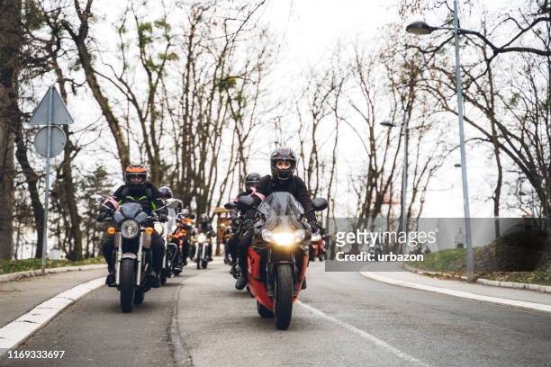 female bikers on road - motorbike stock pictures, royalty-free photos & images
