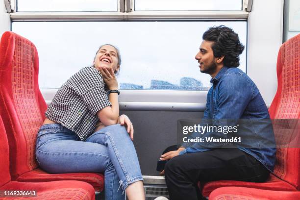 friends travelling by train on rainy day having fun, london, uk - railways uk stock pictures, royalty-free photos & images