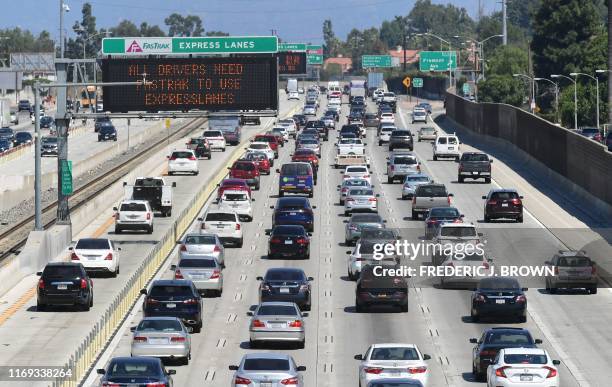 Traffic flows east on the Interstate 10 freeway down FasTrak express lanes and regular lanes in Los Angeles on September 18, 2019. - President Donald...