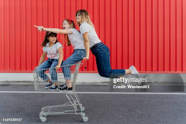 mother with her children with shopping cart - shopping fun stock pictures, royalty-free photos & images